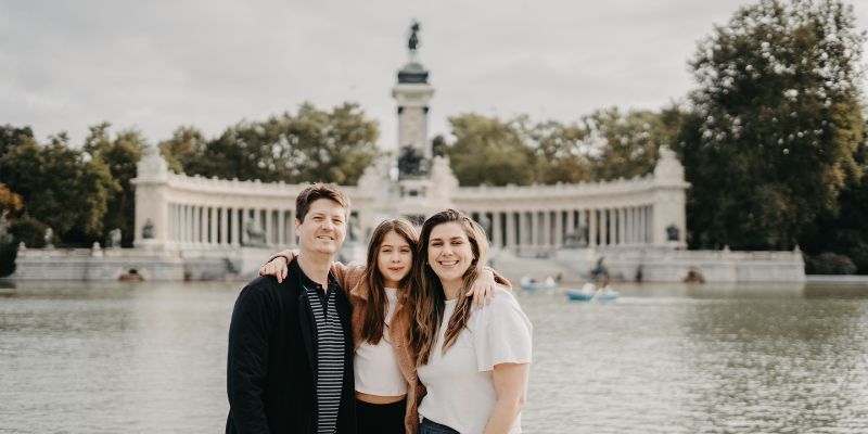 familia em frente a grande lago com monumento ao fundo